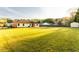 Expansive backyard with lush lawn, mature trees, and a storage shed, perfect for outdoor activities and relaxation at 1250 Great Oaks Se Dr, Conyers, GA 30013