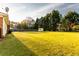 Lush backyard with mature trees, a storage shed, and well-maintained lawn, offering a private outdoor space at 1250 Great Oaks Se Dr, Conyers, GA 30013