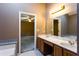 Bathroom featuring a double vanity and marble countertops, with a view to the bedroom at 1250 Great Oaks Se Dr, Conyers, GA 30013