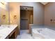 Bathroom with marble countertops, white tiled floors, and a separate tub and shower at 1250 Great Oaks Se Dr, Conyers, GA 30013