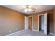Cozy bedroom features neutral walls, carpet, ceiling fan, and closet, offering comfort and functionality at 1250 Great Oaks Se Dr, Conyers, GA 30013
