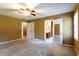 Spacious carpeted bedroom with ceiling fan, connecting to bathroom and closet at 1250 Great Oaks Se Dr, Conyers, GA 30013