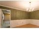 Traditional dining room with wood floors, modern wainscoting, and stylish chandelier at 1250 Great Oaks Se Dr, Conyers, GA 30013