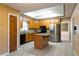 A kitchen with wooden cabinets, stainless steel appliances, a center island and tile flooring at 1250 Great Oaks Se Dr, Conyers, GA 30013