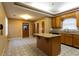 A kitchen with wooden cabinets, black appliances, a center island and tile flooring at 1250 Great Oaks Se Dr, Conyers, GA 30013