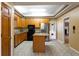 A kitchen with wooden cabinets, black appliances, a center island and tile flooring at 1250 Great Oaks Se Dr, Conyers, GA 30013