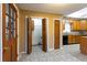 A kitchen with wooden cabinets, an adjacent pantry and tile flooring at 1250 Great Oaks Se Dr, Conyers, GA 30013