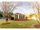 Spacious lawn featuring a low brick wall and large shade trees at 1250 Great Oaks Se Dr, Conyers, GA 30013