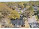A picturesque aerial view highlights the home's proximity to mature trees in a residential neighborhood at 1569 Montreat Sw Ave, Atlanta, GA 30311