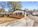Backyard view showing deck, detached garage, and concrete driveway at 1569 Montreat Sw Ave, Atlanta, GA 30311
