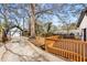 Backyard featuring a wooden deck, detached garage, and a long concrete driveway at 1569 Montreat Sw Ave, Atlanta, GA 30311