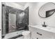 Stylish bathroom featuring a glass shower with dark marble tile and modern fixtures at 1569 Montreat Sw Ave, Atlanta, GA 30311