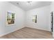 Bright bedroom with two windows, hardwood floors, and white trim at 1569 Montreat Sw Ave, Atlanta, GA 30311