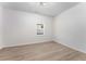 Empty bedroom with light hardwood floors and a single window at 1569 Montreat Sw Ave, Atlanta, GA 30311