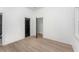 Bedroom with hardwood floors, white walls, and doors, creating a simple, calming atmosphere at 1569 Montreat Sw Ave, Atlanta, GA 30311