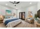 Bright bedroom featuring a ceiling fan, french doors to the outside, and light hardwood floors at 1569 Montreat Sw Ave, Atlanta, GA 30311