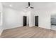 Spacious empty bedroom with light hardwood floors and a bathroom attached at 1569 Montreat Sw Ave, Atlanta, GA 30311