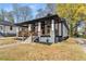 Side view of a freshly renovated bungalow style house with new wooden front porch and professional landscaping at 1569 Montreat Sw Ave, Atlanta, GA 30311