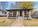 A charming house with inviting front porch, black trim and stone accents offers a warm welcome at 1569 Montreat Sw Ave, Atlanta, GA 30311