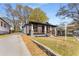 A stylish home with a covered front porch and freshly landscaped yard exudes curb appeal and welcomes visitors at 1569 Montreat Sw Ave, Atlanta, GA 30311
