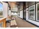 Wide, covered porch with stained wood deck, stone pillars, black door, and white trim at 1569 Montreat Sw Ave, Atlanta, GA 30311