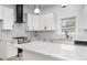 Beautiful kitchen featuring white cabinets, quartz countertops, herringbone backsplash, and stainless steel appliances at 1569 Montreat Sw Ave, Atlanta, GA 30311