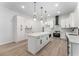 Bright kitchen featuring white cabinets, quartz countertops, herringbone backsplash, and stainless steel appliances at 1569 Montreat Sw Ave, Atlanta, GA 30311