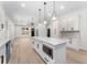 Beautiful open kitchen featuring white cabinets, quartz countertops, herringbone backsplash, and stainless steel appliances at 1569 Montreat Sw Ave, Atlanta, GA 30311