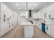 Bright kitchen featuring white cabinets, quartz countertops, herringbone backsplash, and stainless steel appliances at 1569 Montreat Sw Ave, Atlanta, GA 30311