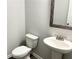 Bathroom includes a white toilet, sink and vanity at 258 Station Overlook Dr, Auburn, GA 30011