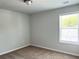 Bright neutral bedroom with a large window and neutral carpet at 258 Station Overlook Dr, Auburn, GA 30011
