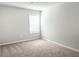 Neutral bedroom with large window and neutral carpet at 258 Station Overlook Dr, Auburn, GA 30011