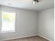Bright neutral bedroom with a large window and neutral carpet at 258 Station Overlook Dr, Auburn, GA 30011