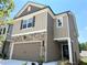 Charming home showcases stone and siding, complemented by a well-kept lawn and a two-car garage at 258 Station Overlook Dr, Auburn, GA 30011