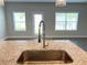 Kitchen island granite countertops with a stainless steel sink and faucet at 258 Station Overlook Dr, Auburn, GA 30011