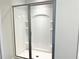Enclosed shower with sliding glass doors and built-in shelving at 258 Station Overlook Dr, Auburn, GA 30011