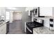 Modern kitchen featuring stainless steel appliances, granite countertops, a gas range, and abundant natural light at 4502 Lake Park Dr, Acworth, GA 30101