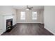 Spacious living room with fireplace, ceiling fan, and modern flooring for comfort and style at 4502 Lake Park Dr, Acworth, GA 30101