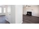 Open-concept living area with fireplace, ceiling fan, and durable flooring, blending style with functionality at 4502 Lake Park Dr, Acworth, GA 30101