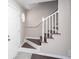 Bright foyer with staircase featuring white railings and wood steps, leading to the upper level at 4502 Lake Park Dr, Acworth, GA 30101