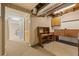 View of basement with exposed ceiling and wooden desk area at 877 Old Farm Walk, Marietta, GA 30066