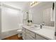 Clean bathroom featuring a tub and shower, a vanity with storage, and a bright, inviting atmosphere at 877 Old Farm Walk, Marietta, GA 30066