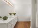 Bright bathroom featuring a double sink vanity, large mirror, and modern lighting fixtures at 877 Old Farm Walk, Marietta, GA 30066
