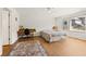 Bright bedroom with large window, wooden floors, ceiling fan, and desk at 877 Old Farm Walk, Marietta, GA 30066