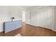 Spacious bedroom with a large dresser, closet, and wood-look flooring, providing ample storage and style at 877 Old Farm Walk, Marietta, GA 30066