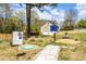 Outdoor community garden area with stone path and welcome sign at 877 Old Farm Walk, Marietta, GA 30066