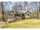 Well-maintained home with a welcoming front entrance, surrounded by lush green lawn and trees at 877 Old Farm Walk, Marietta, GA 30066