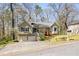 Split-level home with a two-car garage, nestled among trees in a suburban setting at 877 Old Farm Walk, Marietta, GA 30066