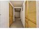 Basement hallway featuring closet storage with paneled doors at 877 Old Farm Walk, Marietta, GA 30066