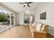 Cozy living room featuring hardwood floors, a brick fireplace, and natural light at 877 Old Farm Walk, Marietta, GA 30066